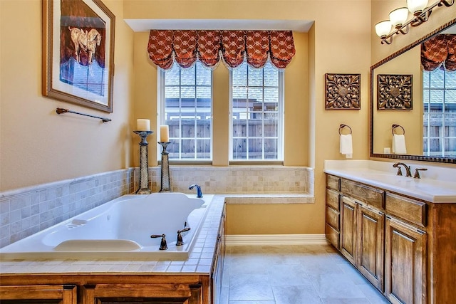 10853 Dixon Branch Dr, Dallas, TX 75218 - bathroom featuring vanity, a garden tub, healthy amount of natural light, and baseboards