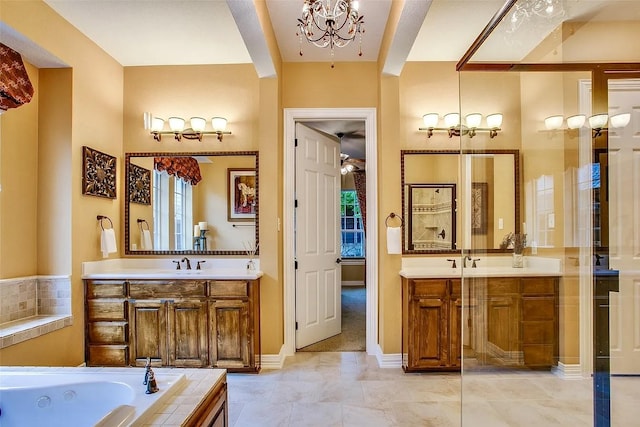10853 Dixon Branch Dr, Dallas, TX 75218 - bathroom with two vanities, a chandelier, a tub with jets, and tile patterned flooring