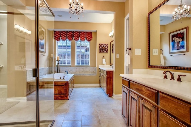 10853 Dixon Branch Dr, Dallas, TX 75218 - full bath with a chandelier, two vanities, a garden tub, and baseboards