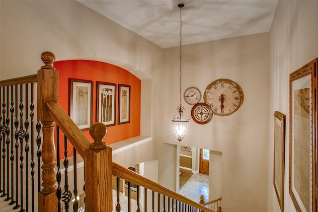 10853 Dixon Branch Dr, Dallas, TX 75218 - hall with arched walkways, baseboards, and an upstairs landing