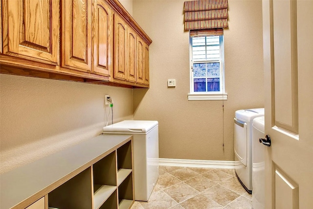 10853 Dixon Branch Dr, Dallas, TX 75218 - washroom featuring washer and clothes dryer, cabinet space, and baseboards