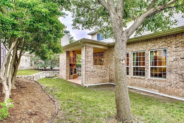 10853 Dixon Branch Dr, Dallas, TX 75218 - view of side of home with brick siding, a chimney, and a yard
