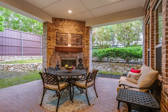 10853 Dixon Branch Dr, Dallas, TX 75218 - view of patio / terrace featuring outdoor dining area, fence, and an outdoor brick fireplace