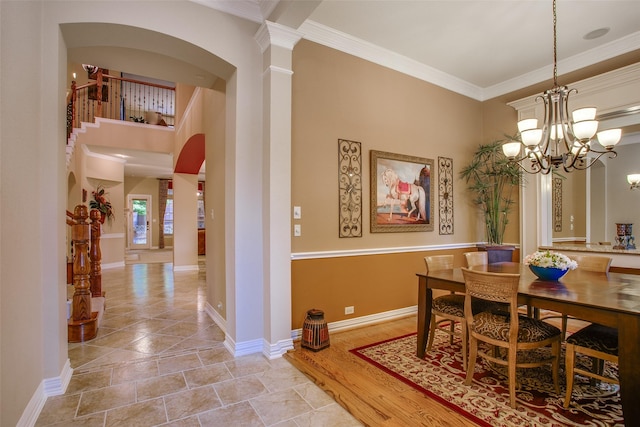 10853 Dixon Branch Dr, Dallas, TX 75218 - dining room featuring a chandelier, baseboards, ornamental molding, and arched walkways