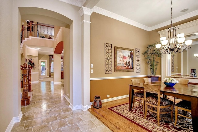 10853 Dixon Branch Dr, Dallas, TX 75218 - dining area featuring crown molding, arched walkways, a chandelier, ornate columns, and baseboards