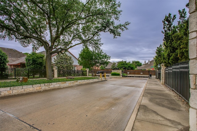 10853 Dixon Branch Dr, Dallas, TX 75218 - view of road with traffic signs, a gated entry, and curbs