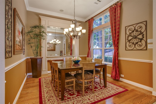 10853 Dixon Branch Dr, Dallas, TX 75218 - dining space with a chandelier, light wood-style flooring, and crown molding