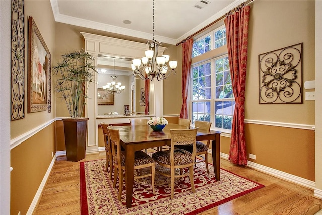 10853 Dixon Branch Dr, Dallas, TX 75218 - dining room featuring light wood-style flooring, a chandelier, healthy amount of natural light, crown molding, and baseboards