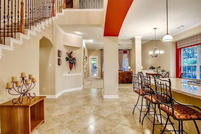 10853 Dixon Branch Dr, Dallas, TX 75218 - tiled foyer entrance with baseboards, ornamental molding, decorative columns, arched walkways, and a chandelier