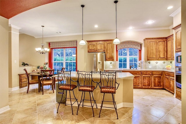 10853 Dixon Branch Dr, Dallas, TX 75218 - kitchen featuring appliances with stainless steel finishes, plenty of natural light, backsplash, a kitchen bar, and ornamental molding