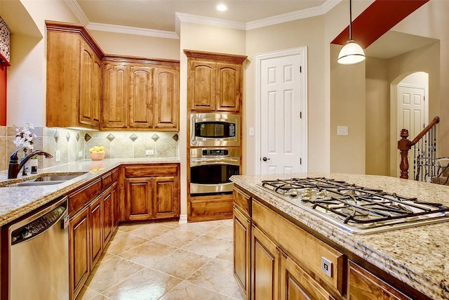 10853 Dixon Branch Dr, Dallas, TX 75218 - kitchen with appliances with stainless steel finishes, arched walkways, a sink, tasteful backsplash, and pendant lighting