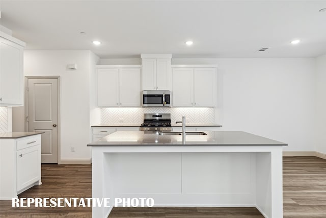1359 Whipsaw Trl, Celina, TX 75009 - kitchen featuring a sink, stainless steel appliances, visible vents, dark wood-type flooring, and tasteful backsplash