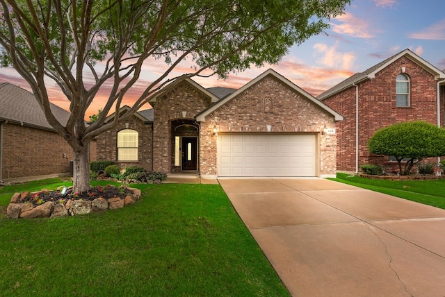 4416 Coney Island Dr, Frisco, TX 75036 - view of front of house featuring an attached garage, brick siding, driveway, and a yard