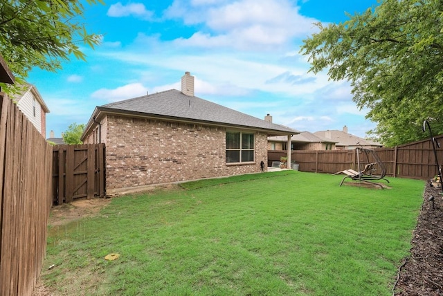 4416 Coney Island Dr, Frisco, TX 75036 - rear view of property with a chimney, a lawn, a fenced backyard, brick siding, and roof with shingles