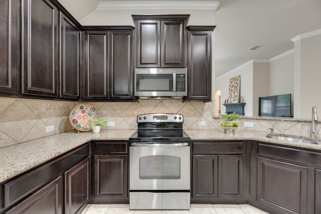 4416 Coney Island Dr, Frisco, TX 75036 - kitchen featuring light stone counters, visible vents, a sink, dark brown cabinetry, and appliances with stainless steel finishes