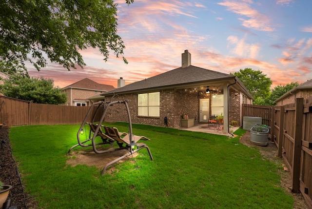 4416 Coney Island Dr, Frisco, TX 75036 - rear view of property with a lawn, a patio, brick siding, and a fenced backyard