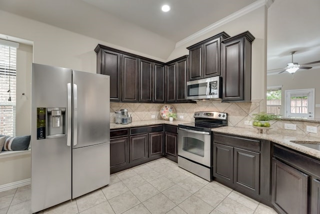 4416 Coney Island Dr, Frisco, TX 75036 - kitchen featuring light stone countertops, light tile patterned floors, dark brown cabinetry, stainless steel appliances, and tasteful backsplash