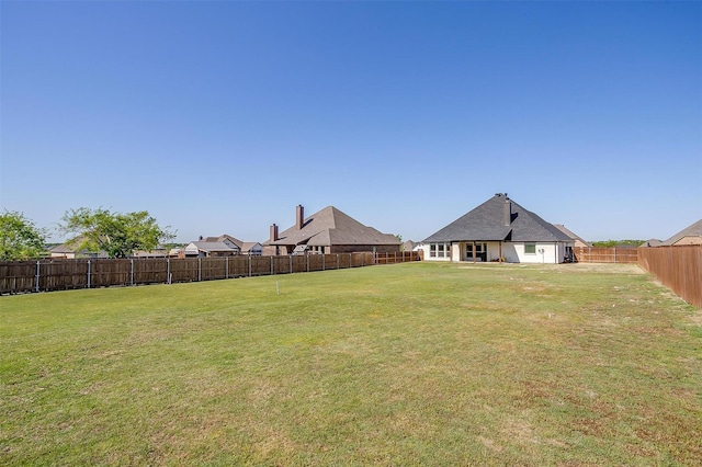 view of yard with a fenced backyard