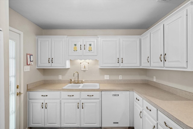 kitchen featuring light countertops, white cabinetry, a sink, and white dishwasher