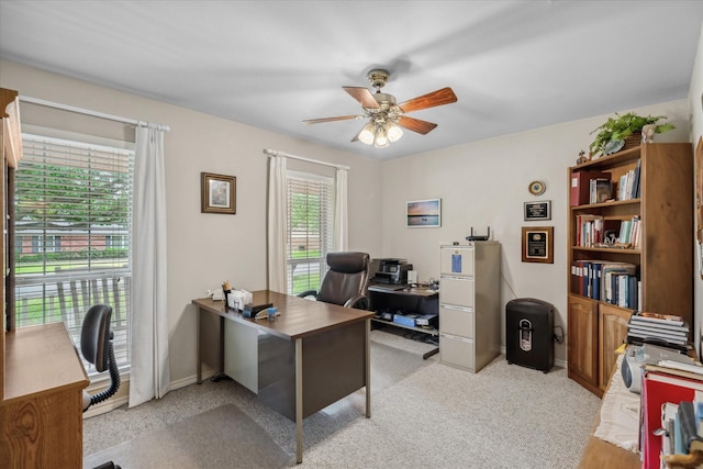 office area with ceiling fan and light carpet
