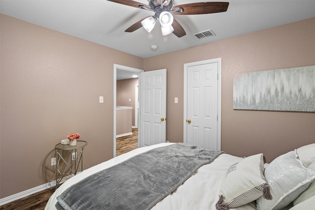 bedroom featuring wood finished floors, baseboards, and a ceiling fan
