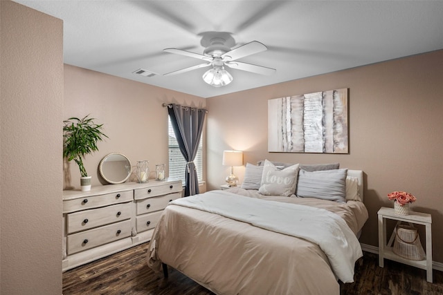 bedroom with dark wood-style floors, ceiling fan, and baseboards