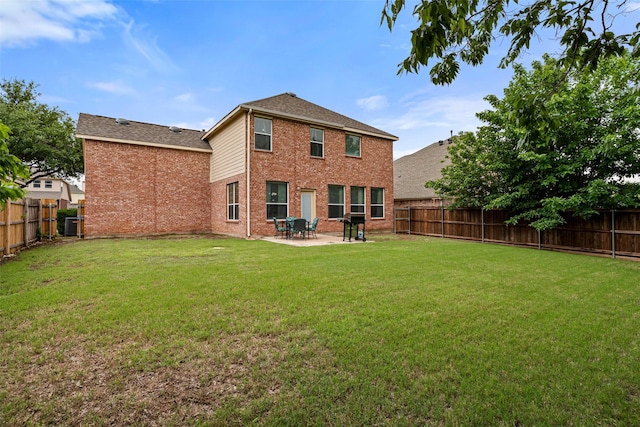 back of property with brick siding, a patio area, and roof with shingles