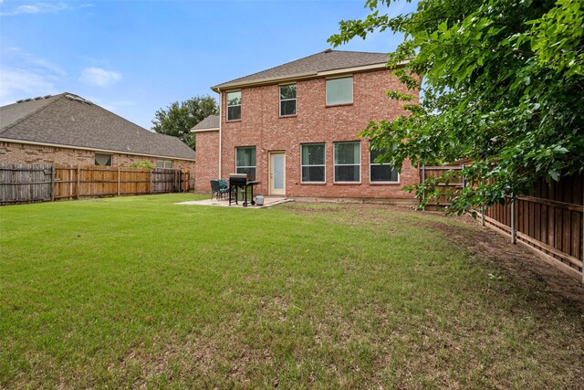 rear view of house featuring a patio area and brick siding