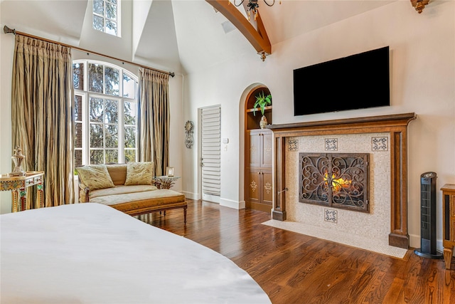 1719 Byron Nelson Pkwy, Colleyville, TX 76092 - bedroom featuring wood finished floors, high vaulted ceiling, a fireplace, baseboards, and arched walkways