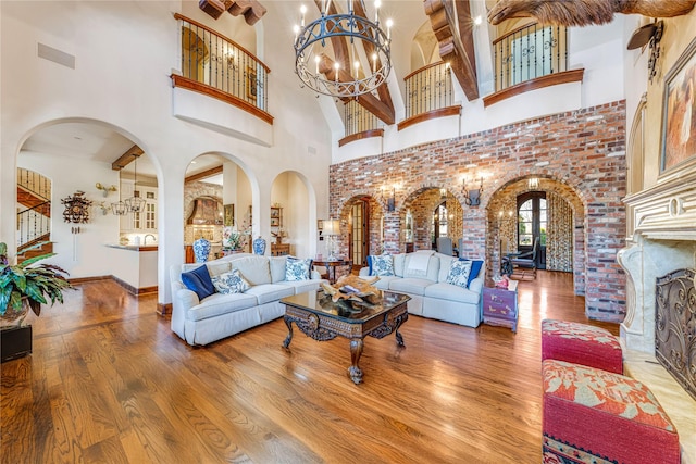 1719 Byron Nelson Pkwy, Colleyville, TX 76092 - living area with a chandelier, wood finished floors, a towering ceiling, and arched walkways
