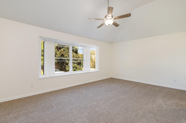spare room with vaulted ceiling, baseboards, a ceiling fan, and carpet floors