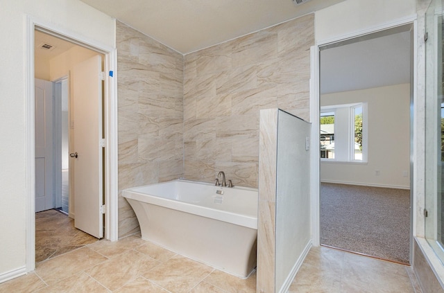 bathroom with a soaking tub