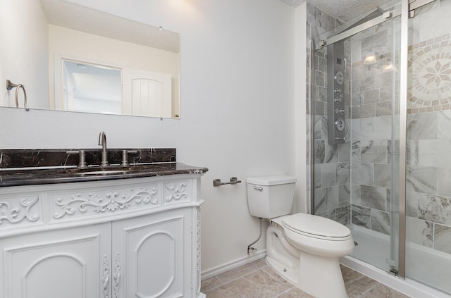 full bathroom featuring vanity, toilet, baseboards, and a stall shower