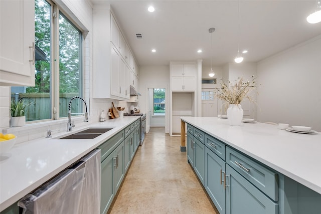 kitchen featuring recessed lighting, tasteful backsplash, a sink, white cabinets, and appliances with stainless steel finishes