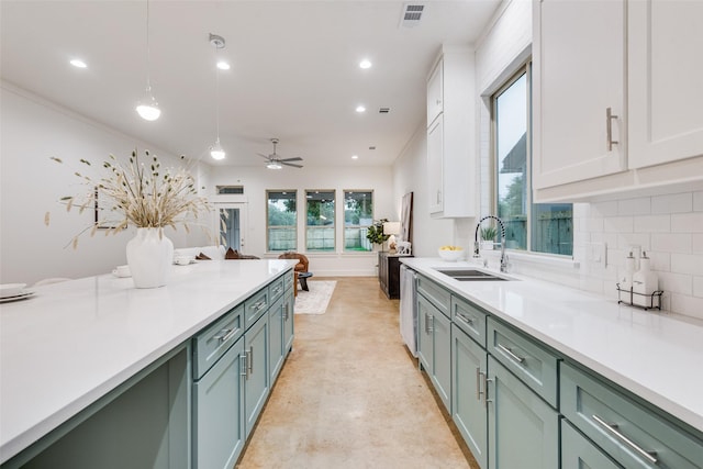 kitchen with visible vents, a sink, white cabinetry, light countertops, and tasteful backsplash