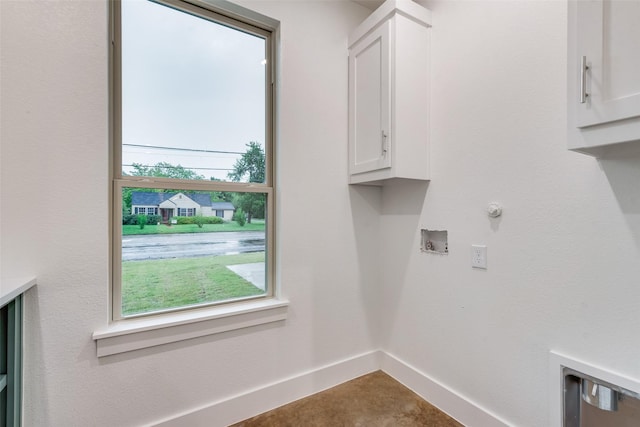laundry area with cabinet space, baseboards, and hookup for a washing machine