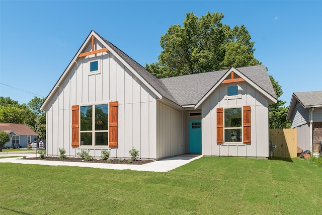 modern inspired farmhouse featuring board and batten siding and a shingled roof