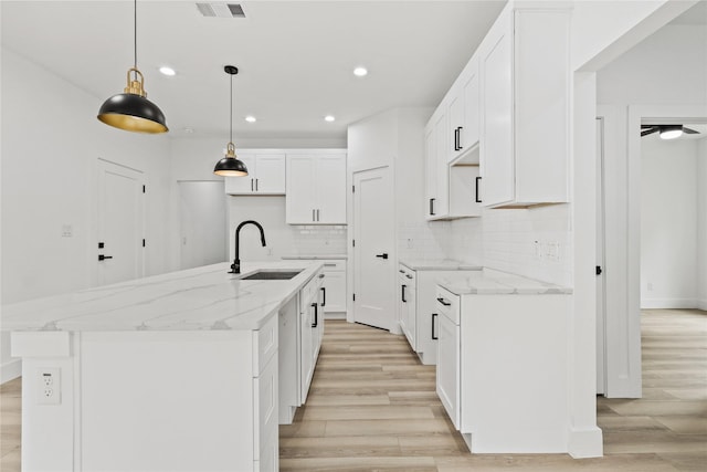 7819 Brownsville Ave, Dallas, TX 75216 - kitchen featuring a sink, visible vents, recessed lighting, light wood-style flooring, and backsplash