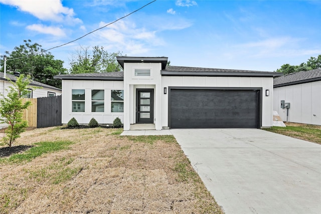 7819 Brownsville Ave, Dallas, TX 75216 - view of front facade featuring fence, a garage, concrete driveway, a front yard, and roof with shingles