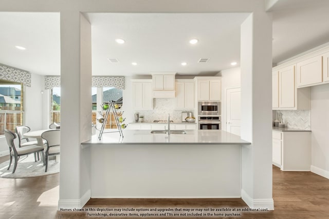 4029 Alpine St, Midlothian, TX 76065 - kitchen featuring a sink, tasteful backsplash, dark wood-type flooring, visible vents, and appliances with stainless steel finishes