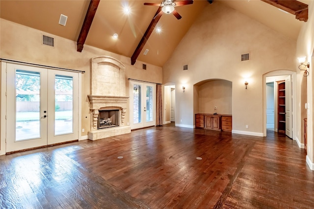 unfurnished living room featuring french doors, visible vents, and high vaulted ceiling