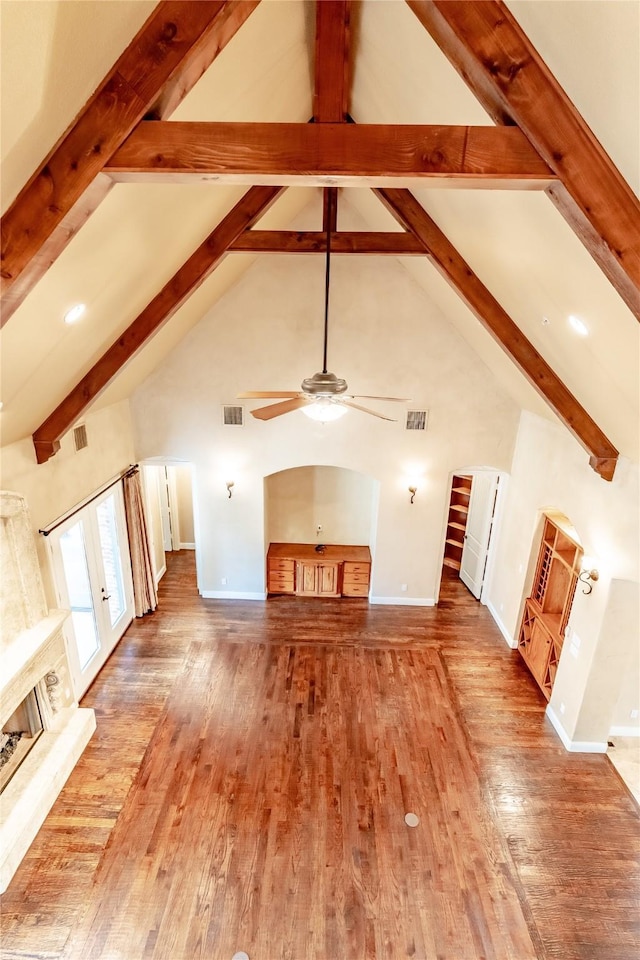 unfurnished living room with visible vents, wood finished floors, and a ceiling fan