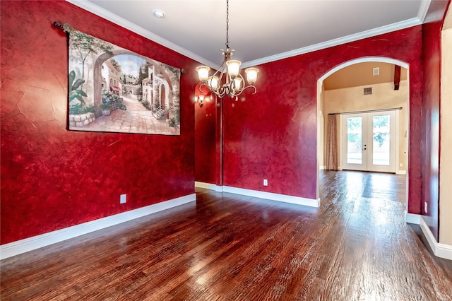 unfurnished room featuring french doors, wood finished floors, baseboards, and arched walkways