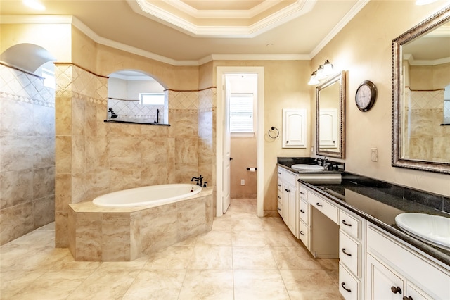 bathroom featuring a tray ceiling, ornamental molding, a sink, double vanity, and tiled tub