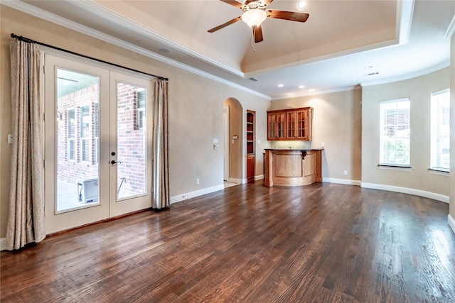 unfurnished living room featuring ceiling fan, french doors, arched walkways, and dark wood-style floors