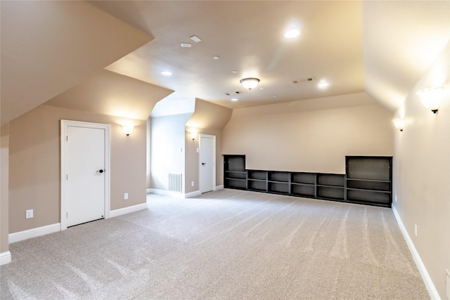additional living space featuring baseboards, visible vents, and carpet floors