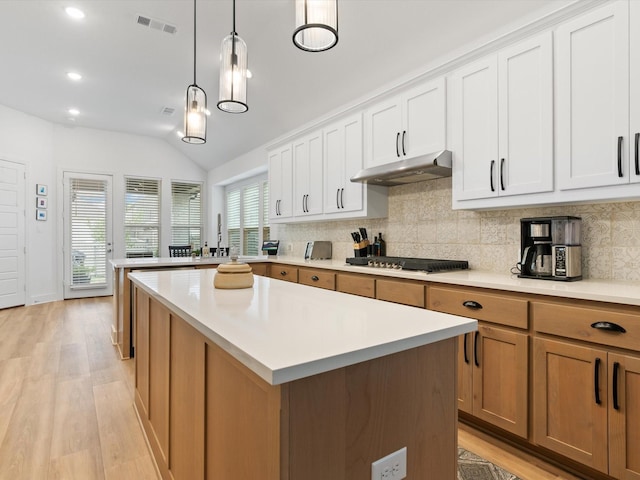 1509 Horizon Way, Northlake, TX 76247 - kitchen featuring backsplash, under cabinet range hood, light countertops, light wood-style floors, and stainless steel gas cooktop