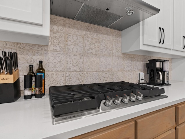 1509 Horizon Way, Northlake, TX 76247 - kitchen featuring white cabinets, under cabinet range hood, light countertops, stainless steel gas stovetop, and tasteful backsplash