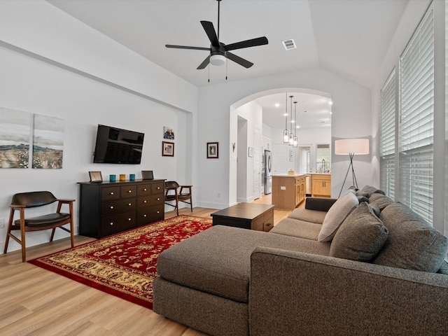 1509 Horizon Way, Northlake, TX 76247 - living area with light wood-type flooring, vaulted ceiling, a ceiling fan, and arched walkways