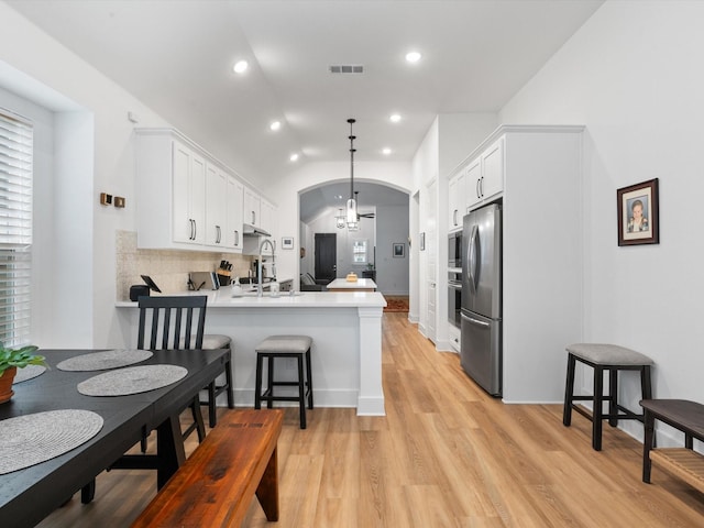 1509 Horizon Way, Northlake, TX 76247 - kitchen with a sink, a peninsula, lofted ceiling, visible vents, and appliances with stainless steel finishes